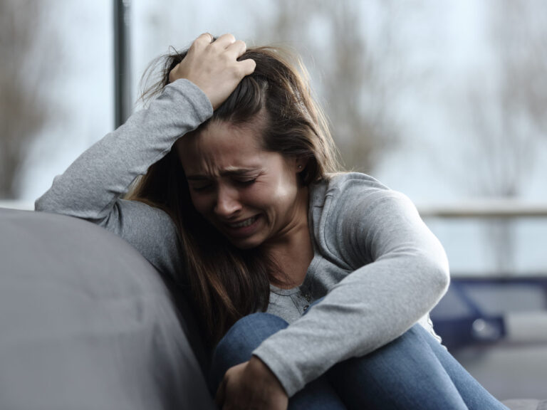 Sad girl complaining and crying at home